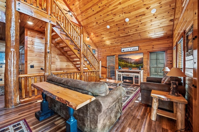 living room with dark hardwood / wood-style flooring, high vaulted ceiling, wood ceiling, and wood walls