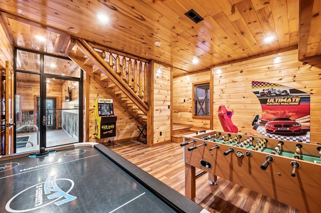 rec room with wood ceiling, wooden walls, and hardwood / wood-style floors