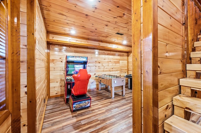 living area with hardwood / wood-style floors and wood walls