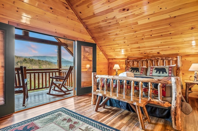 bedroom featuring hardwood / wood-style flooring, lofted ceiling, wood ceiling, and wood walls