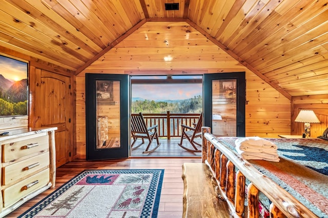 bedroom with wood ceiling, vaulted ceiling, dark hardwood / wood-style floors, and wood walls