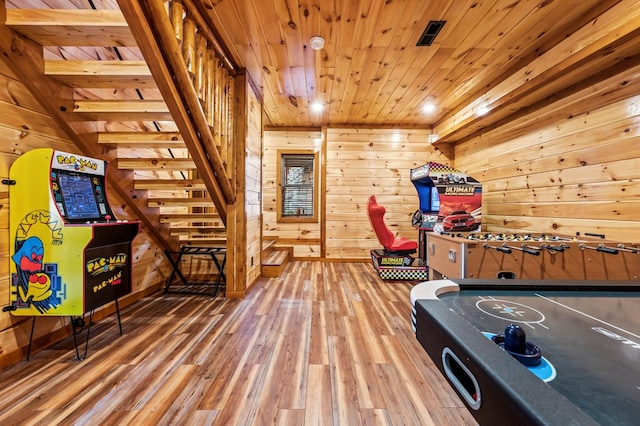 game room featuring hardwood / wood-style floors, wooden ceiling, and wood walls