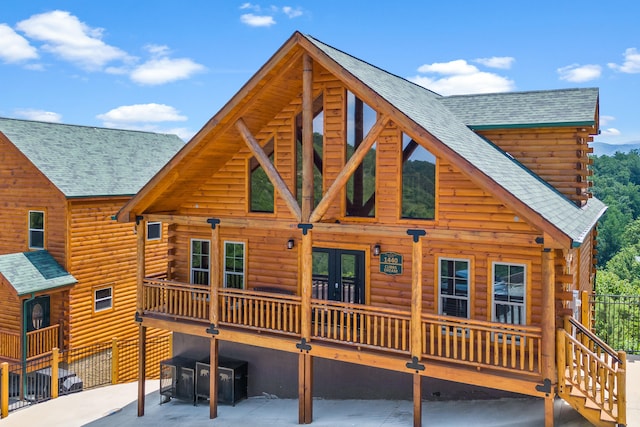 rear view of property with french doors and a balcony