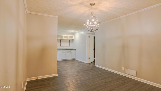 200 Alhambra Rd, Oak Ridge, TN 37830 - unfurnished dining area featuring a chandelier, ornamental molding, dark wood-style flooring, a textured ceiling, and baseboards