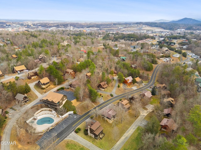 aerial overview of property's location with a pool and a mountain backdrop