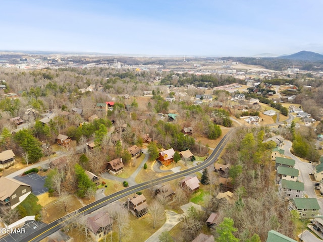 aerial view of property's location with nearby suburban area and a mountain backdrop