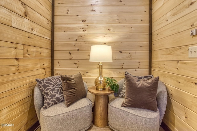 sitting room featuring wooden walls