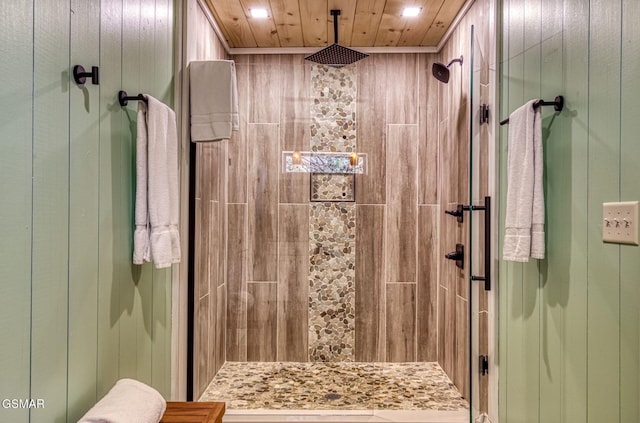 bathroom with a stall shower, recessed lighting, and wood walls