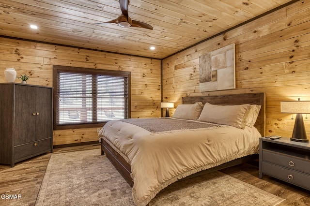 bedroom with wooden ceiling, wood walls, wood finished floors, and recessed lighting