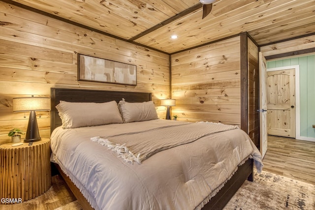 bedroom with wooden ceiling, wooden walls, and wood finished floors
