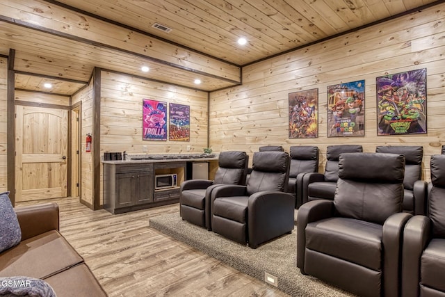 cinema with wood ceiling, wooden walls, bar area, light wood finished floors, and recessed lighting
