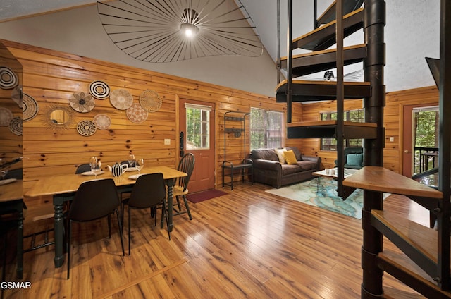 1503 Squirrel Nest Way, Sevierville, TN 37876 - dining area with wood walls, plenty of natural light, hardwood / wood-style flooring, and high vaulted ceiling