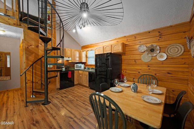 1503 Squirrel Nest Way, Sevierville, TN 37876 - dining space featuring stairs, light wood finished floors, lofted ceiling, wooden walls, and baseboards