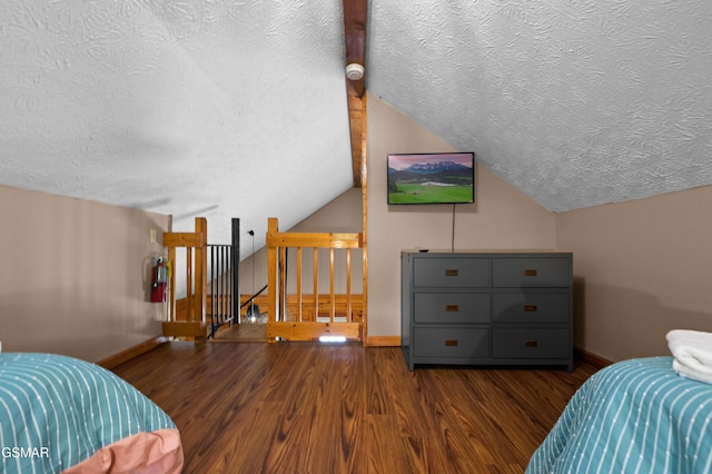 1503 Squirrel Nest Way, Sevierville, TN 37876 - bedroom featuring a textured ceiling, wood finished floors, baseboards, and vaulted ceiling