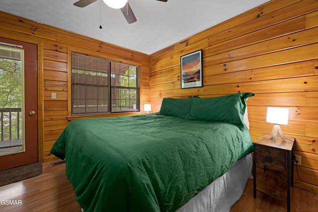 1503 Squirrel Nest Way, Sevierville, TN 37876 - bedroom with wooden walls, wood finished floors, and a ceiling fan