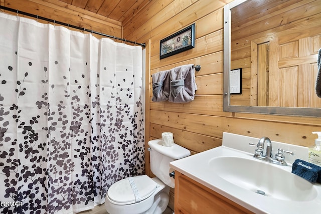 bathroom featuring vanity, wooden walls, wooden ceiling, and toilet