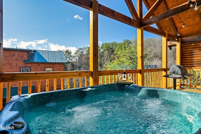 exterior space featuring a hot tub and a deck