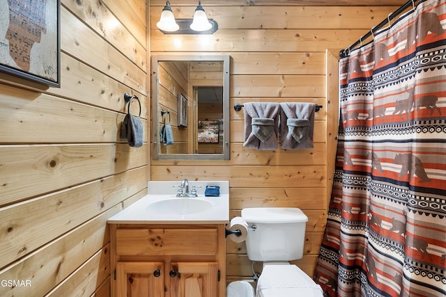 bathroom featuring a shower with curtain, vanity, wooden walls, and toilet