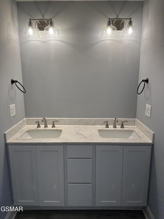 bathroom featuring a sink and double vanity