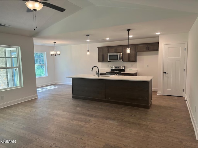 kitchen with dark brown cabinetry, appliances with stainless steel finishes, a sink, lofted ceiling, and visible vents