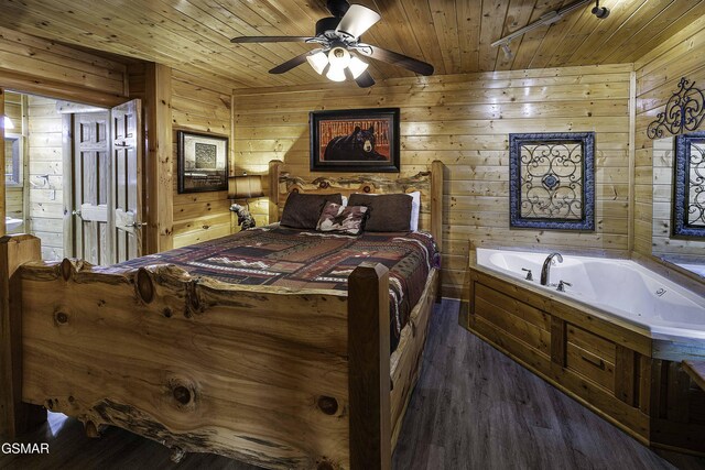 bedroom with dark hardwood / wood-style floors, ceiling fan, wood walls, and wood ceiling