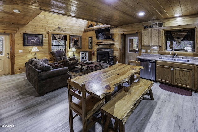 interior space featuring wood walls, sink, wooden ceiling, and light hardwood / wood-style flooring