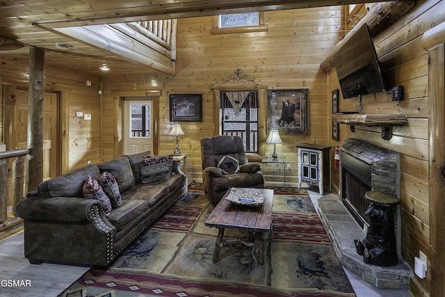 living room featuring wooden walls, a fireplace, and wood ceiling