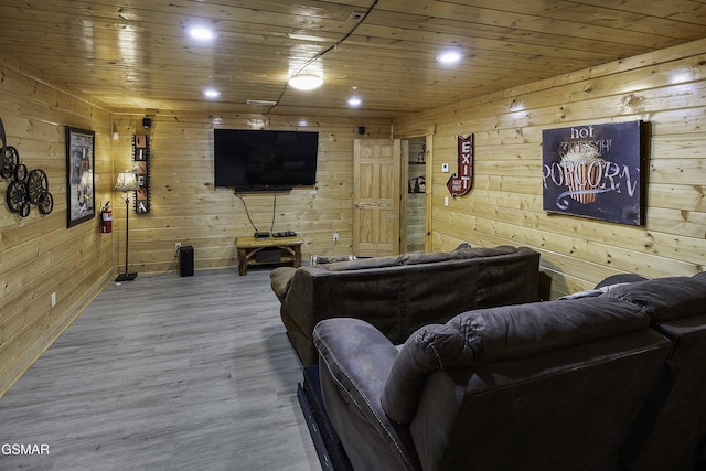 cinema room with hardwood / wood-style floors, wooden walls, and wood ceiling