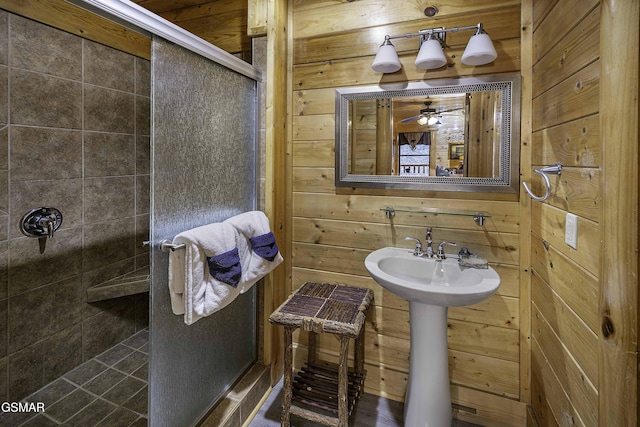 bathroom featuring walk in shower and wood walls