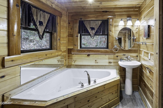 bathroom featuring hardwood / wood-style floors, wood walls, a washtub, and wood ceiling