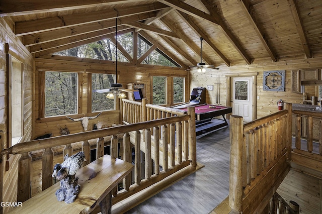 interior space with pool table, wood-type flooring, wooden ceiling, vaulted ceiling with beams, and wood walls