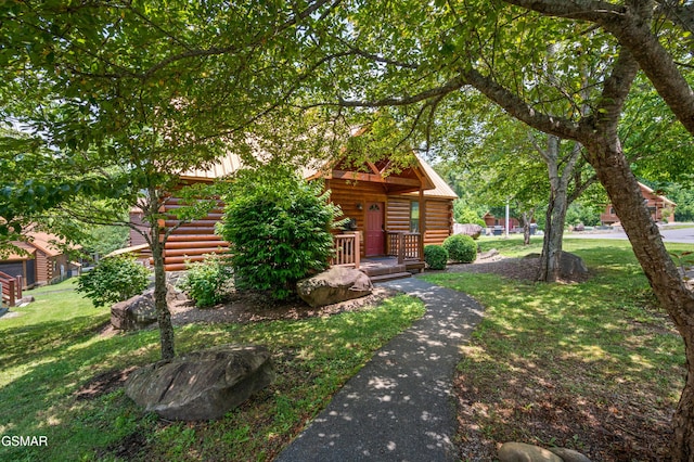 cabin with a front lawn