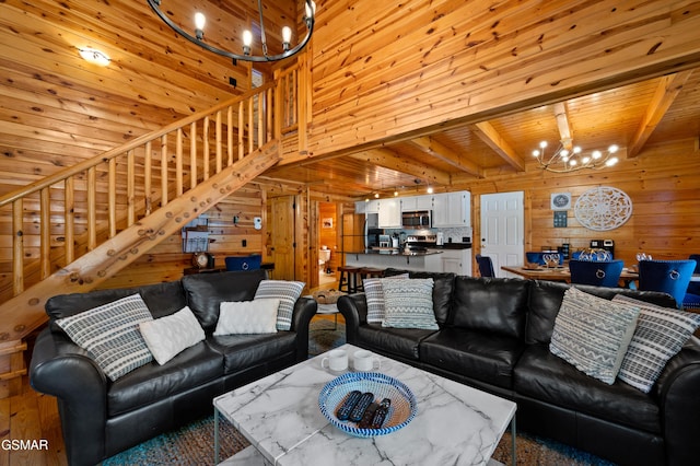 living room featuring beam ceiling, a chandelier, and wooden ceiling