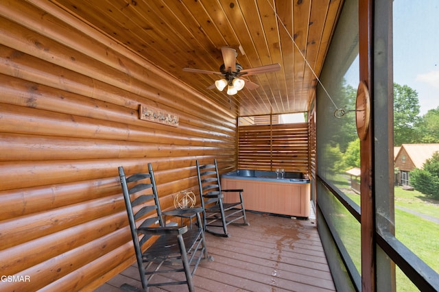 unfurnished sunroom featuring ceiling fan and wood ceiling