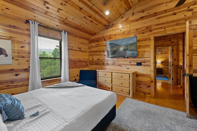 bedroom featuring hardwood / wood-style floors, vaulted ceiling, wood walls, and wood ceiling