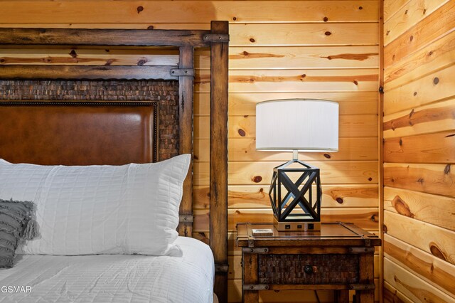 bedroom featuring wooden walls