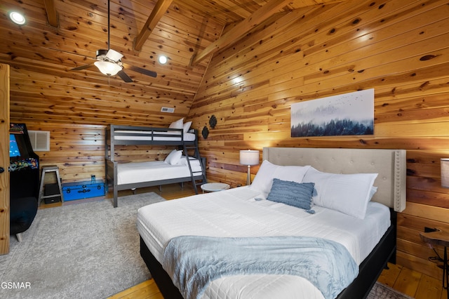 bedroom featuring vaulted ceiling with beams, ceiling fan, wood ceiling, and wooden walls