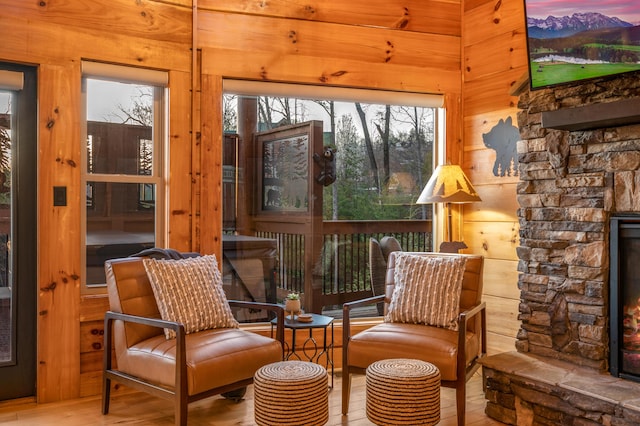 sunroom / solarium with an outdoor stone fireplace