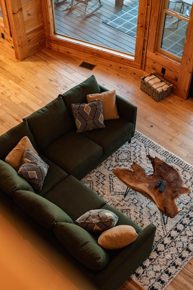 living area with hardwood / wood-style flooring and visible vents