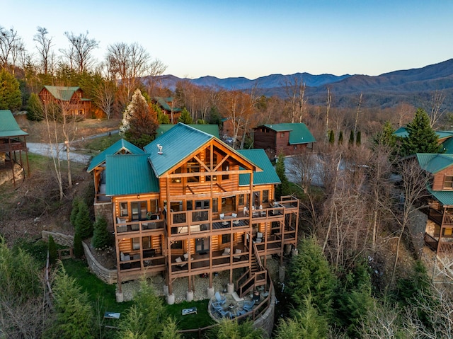 rear view of property with metal roof and a mountain view