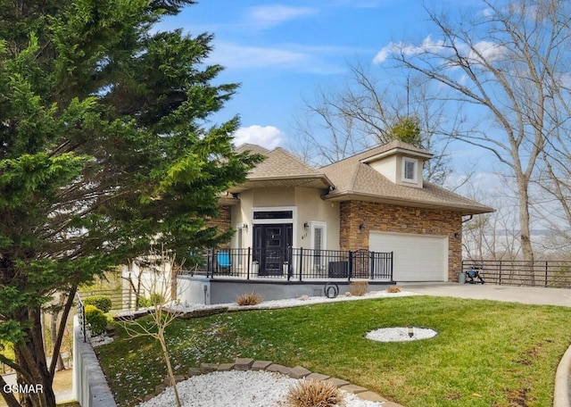 view of front of home with stucco siding, an attached garage, fence, driveway, and a front lawn