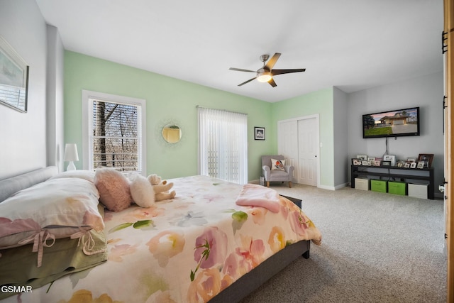 bedroom featuring carpet floors, multiple windows, a closet, and a ceiling fan