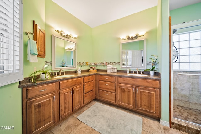 bathroom with double vanity, tile patterned flooring, and a sink