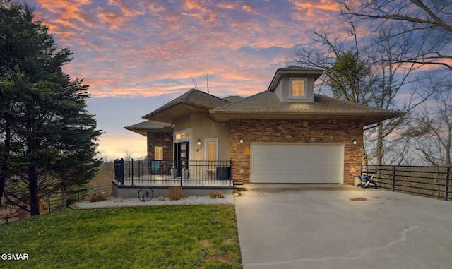 view of front of home with a garage, driveway, fence, and stucco siding