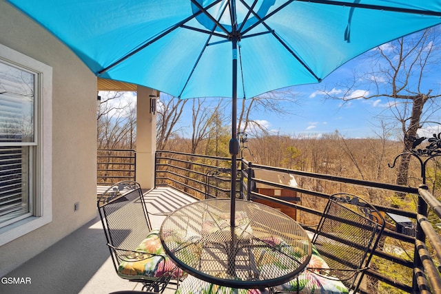 view of patio / terrace with a balcony and outdoor dining space