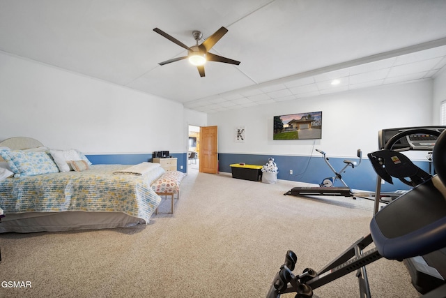 carpeted bedroom featuring a ceiling fan, a paneled ceiling, and baseboards