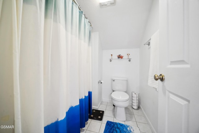 bathroom with baseboards, a shower with shower curtain, toilet, tile patterned floors, and vaulted ceiling