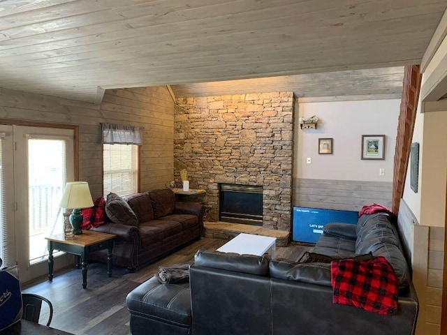 living room featuring vaulted ceiling, wood-type flooring, a fireplace, and wooden ceiling