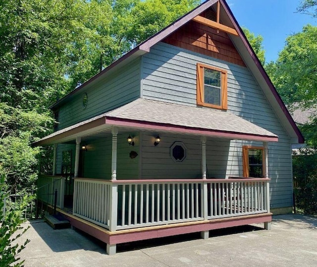 rear view of house featuring covered porch