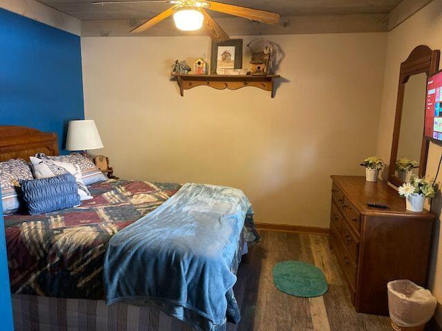 bedroom with ceiling fan and dark hardwood / wood-style floors